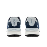 Back heel view of the KURU APOGEE Unisex Sneaker in Indigo-Bright White.