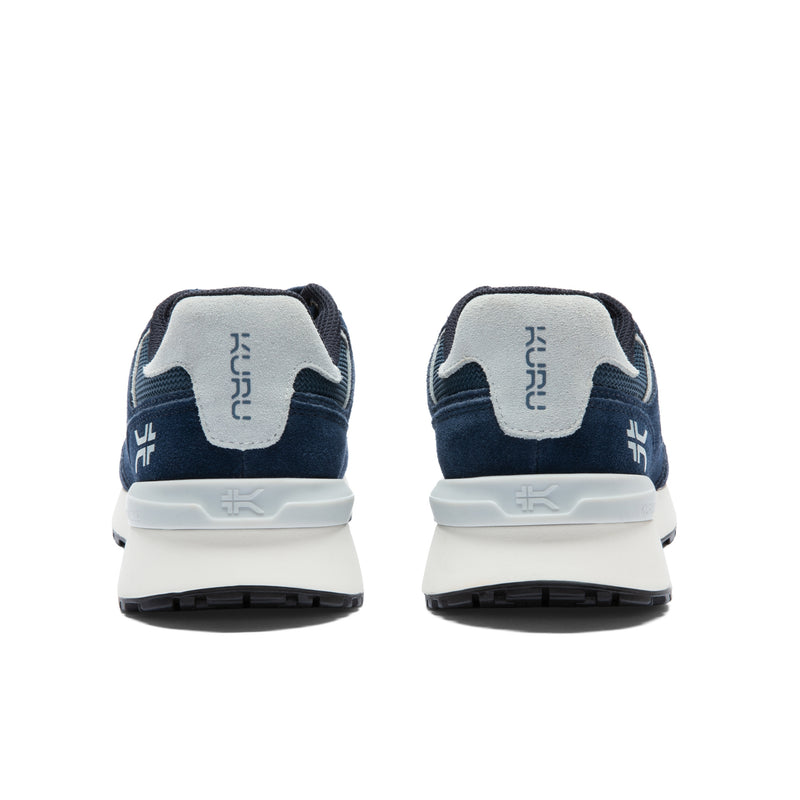 Back heel view of the KURU APOGEE Unisex Sneaker in Indigo-Bright White.