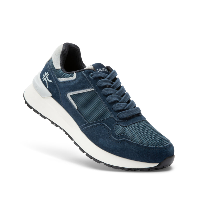 Angled profile view of the KURU APOGEE Unisex Sneaker in Indigo-Bright White.
