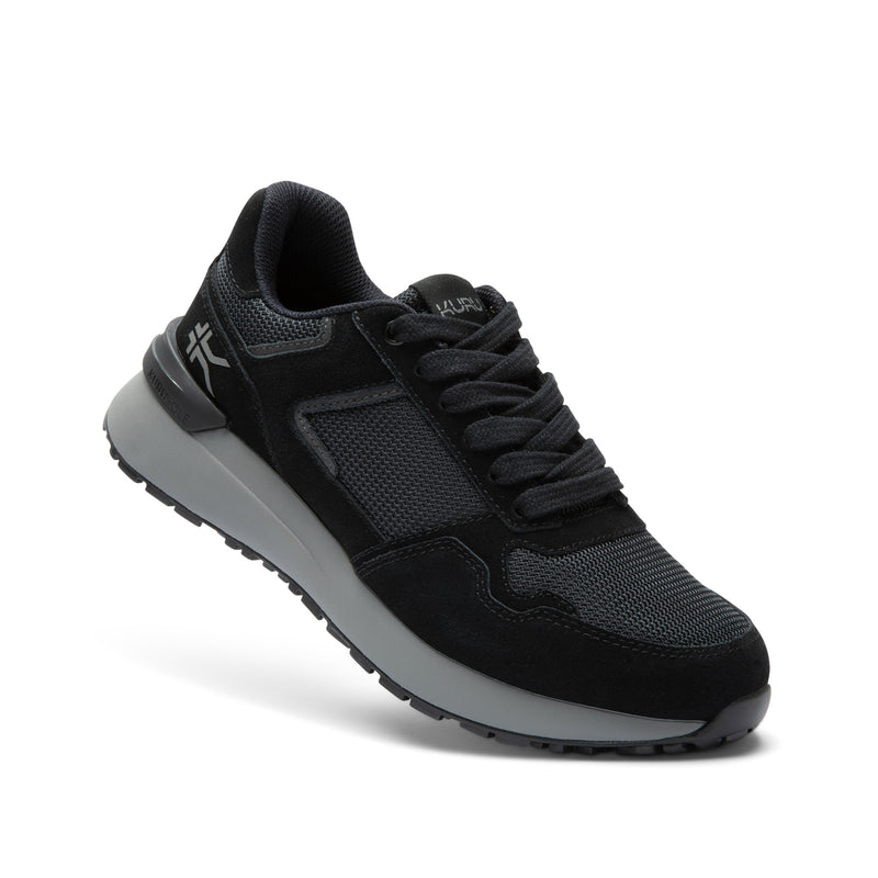 Angled profile view of the KURU APOGEE Unisex Sneaker in Jet Black-Storm Gray.