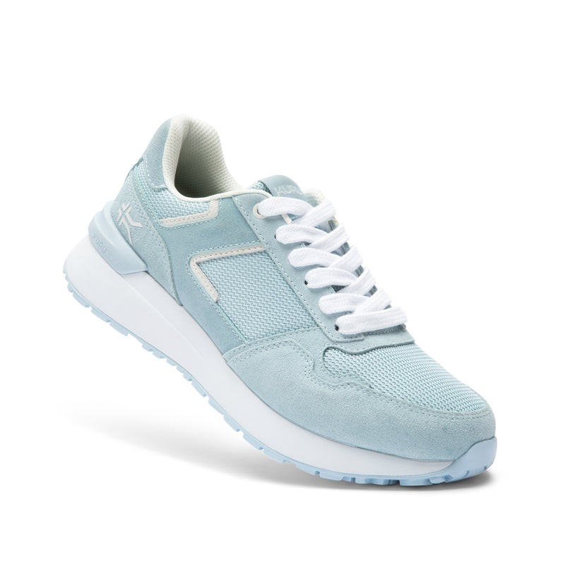 Angled profile view of the KURU APOGEE Unisex Sneaker in Mist Blue-Bright White.