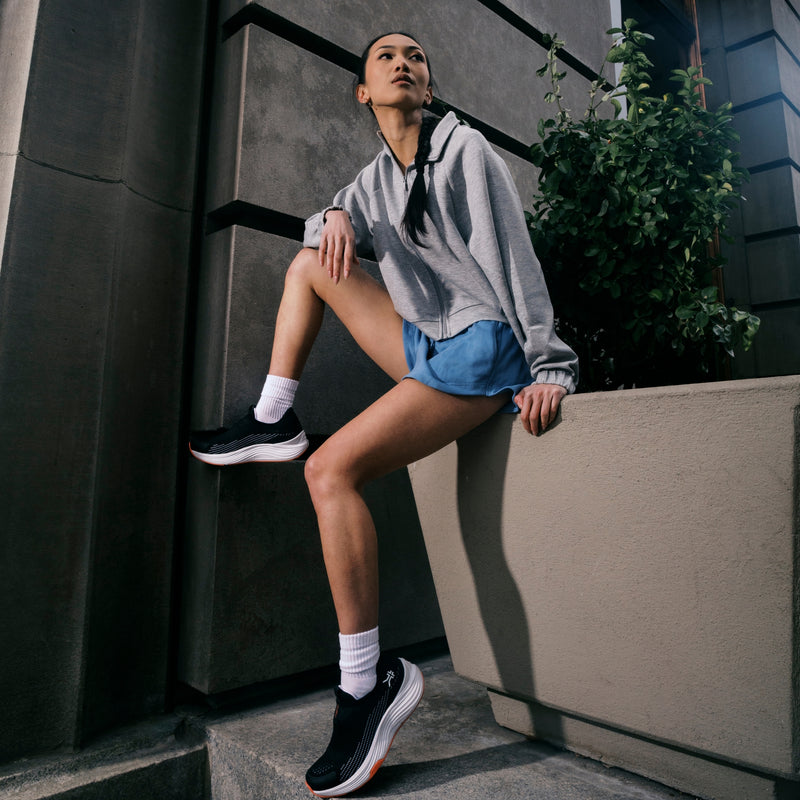 Angled profile view of the KURU ATOM 2 Slip-On Women's Slip-On Sneaker in Jet Black-Dark Coral.
