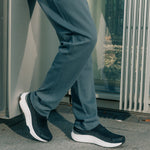 Angled profile view of the KURU ATOM 2 Slip-On Men's Slip-On Sneaker in Jet Black-Bright White.