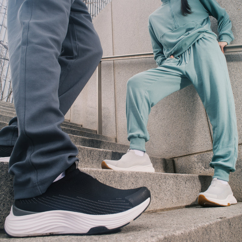 Back heel view of the KURU ATOM 2 Slip-On Men's Slip-On Sneaker in Jet Black-Bright White.