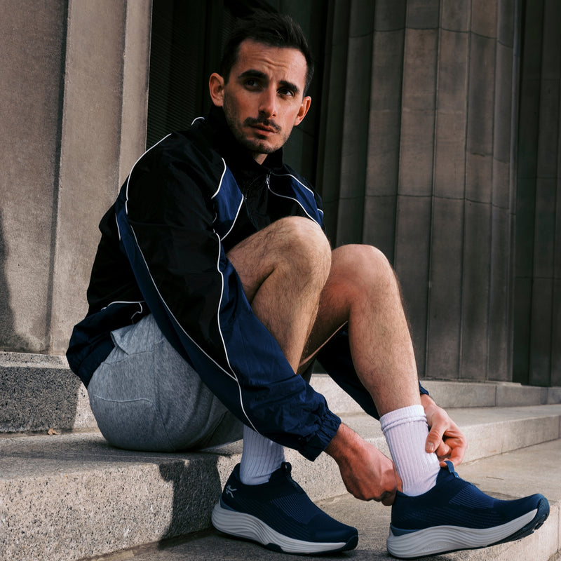 Angled profile view of the KURU ATOM 2 Slip-On Men's Slip-On Sneaker in Mountain Blue-Dove Gray.