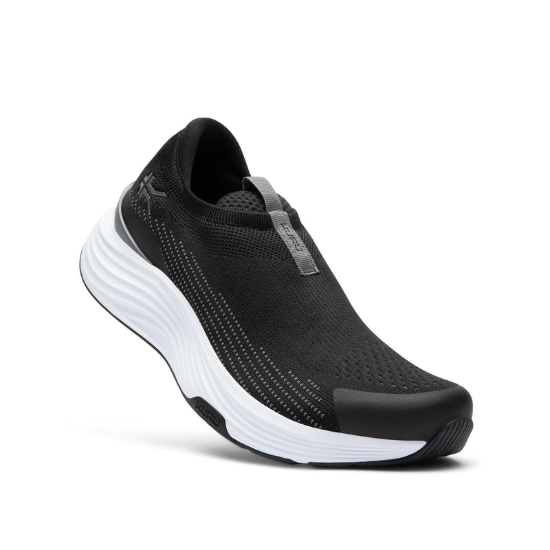 Angled profile view of the KURU ATOM 2 Slip-On Men's Slip-On Sneaker in Jet Black-Bright White.