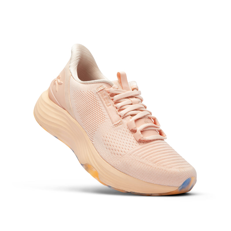 Angled profile view of the KURU ATOM 2 Women's Sneaker in Peach Glacier.