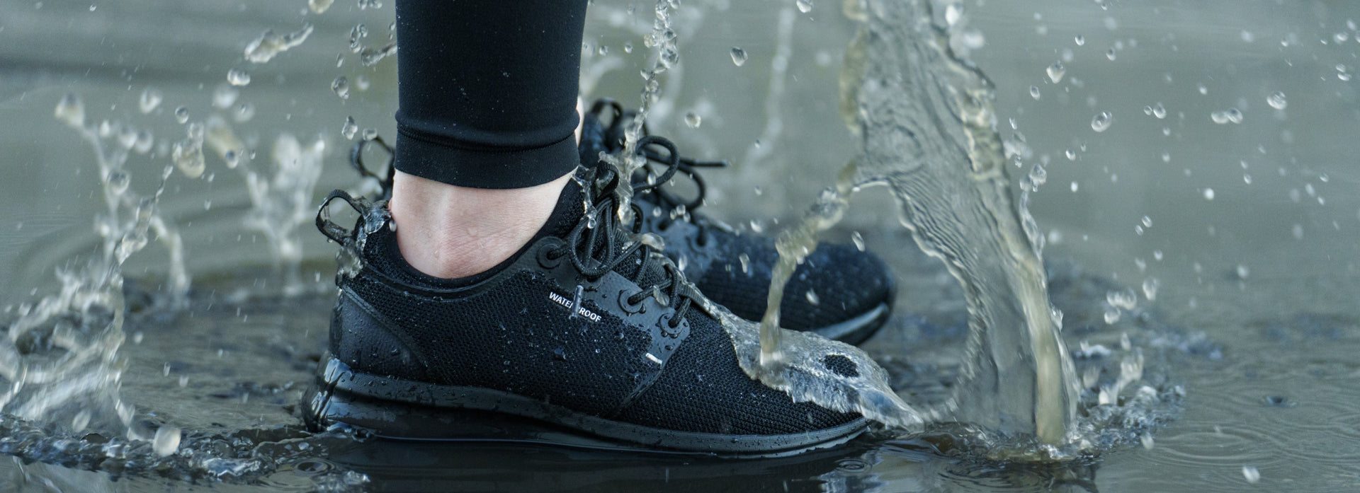 KURU ATOM WP waterproof shoe shown in a puddle, ideal for wet winter conditions.