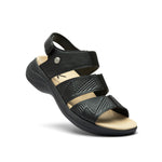 Angled profile view of the KURU CODA Muse Women's Sandal in Jet Black-Emboss.