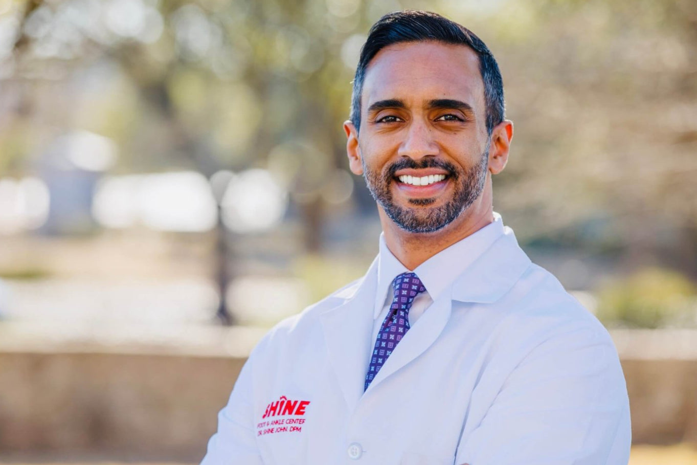 Headshot of Dr. Shine John, a certified podiatrist who medically reviewed this list of best shoes for plantar fasciitis.