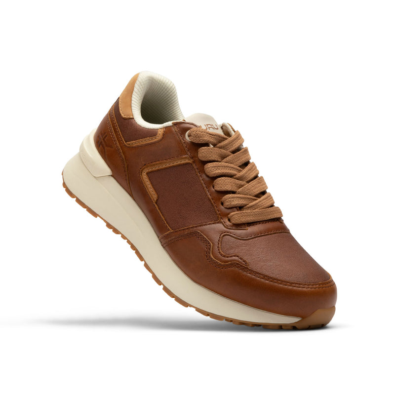 Side profile of the KURU APOGEE Luxe Unisex Leather Sneaker in Cognac Brown-Gum.
