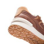 Close-up of the KuruSole and gum outsole on the KURU APOGEE Luxe Unisex Leather Sneaker in Cognac Brown.

