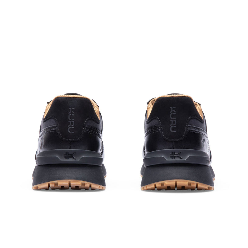 Rear view of the heel and KuruSole on the KURU APOGEE Luxe Unisex Leather Sneaker in Jet Black-Gum.