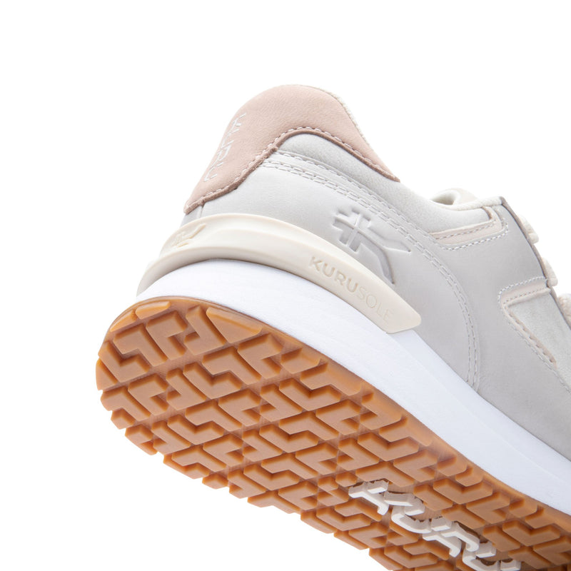 Close-up of the KuruSole and gum outsole on the KURU APOGEE Luxe Unisex Leather Sneaker in Taupe Gray.
