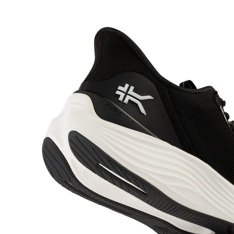Close-up highlighting KURUSOLE technology on the KURU ATOM 2 Men's Athletic Sneaker in Jet Black-Bright White.
