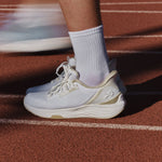 Close-up of the KURU ATOM 2 Women's Athletic Sneaker in Bright White-Sand on a running track.