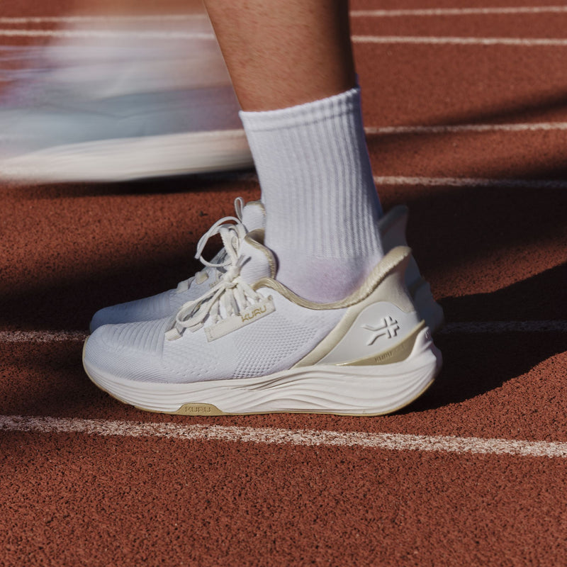 Close-up of the KURU ATOM 2 Women's Athletic Sneaker in Bright White-Sand on a running track.