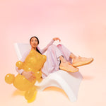 oman wearing KURU ATOM 2 Women's Athletic Sneaker in Peach Glasier.