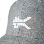 Close-up of the KURU logo embroidery on the KURU Classic Snapback in Charcoal Heather.