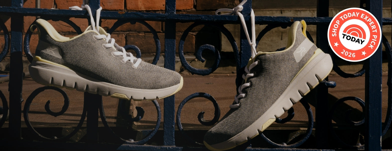 A pair of FLEX Via, hanging from a black wrought iron fence in front of a brick wall. A red circular 'Shop Today Exclusive' badge is in the top right corner.