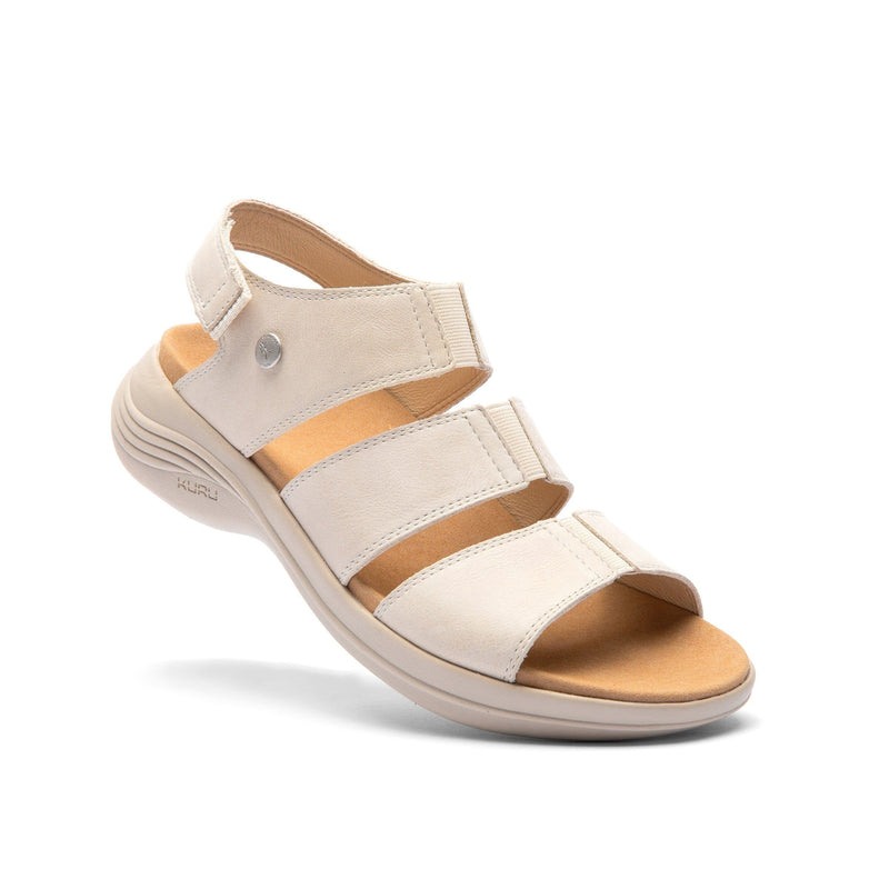 Angled profile view of the KURU CODA Muse Women's Sandal in Shell-Sand.