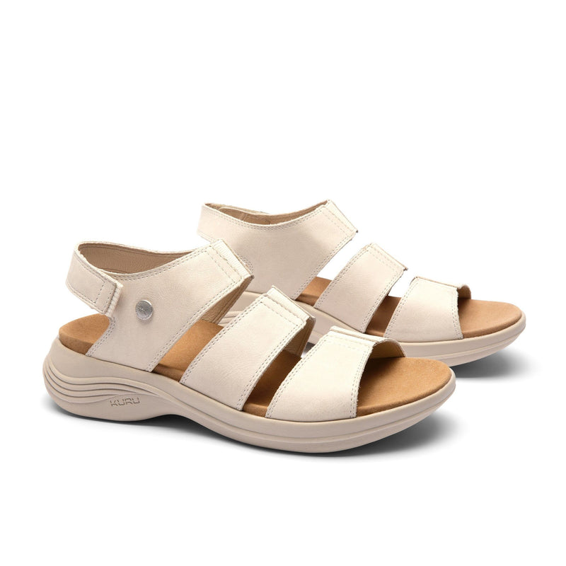 Pair of KURU CODA Muse Women's Sandal in Shell-Sand, angled view.