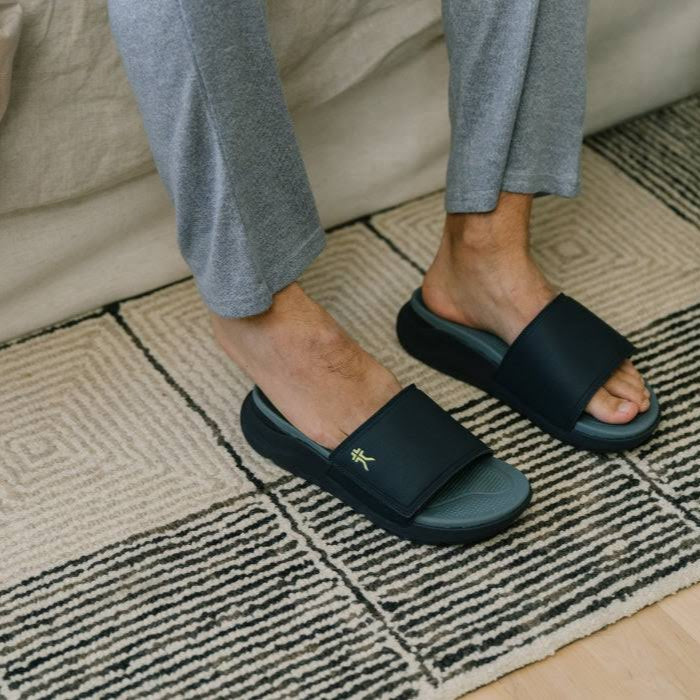 Back heel view of the KURU MOMENT Men's Sandal in Jet Black-Storm Gray.