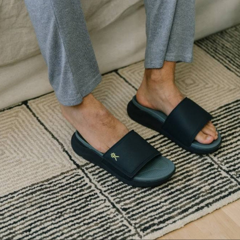 Back heel view of the KURU MOMENT Men's Sandal in Midnight Blue-Pale Lime.