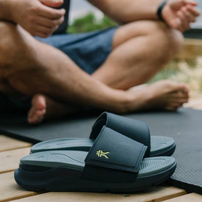 Person wearing the KURU MOMENT Men's Sandal.
