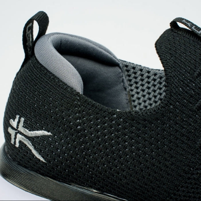 Close-up of the upper material on the KURU ATOM Slip-On Men's Slip-On Sneaker in Jet Black-Slate Gray.