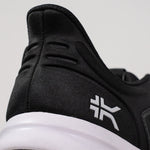 Outsole view of the KURU ATOM Fusion Women's Sneaker in Jet Black-Bright White, showing the KURUSOLE tread.