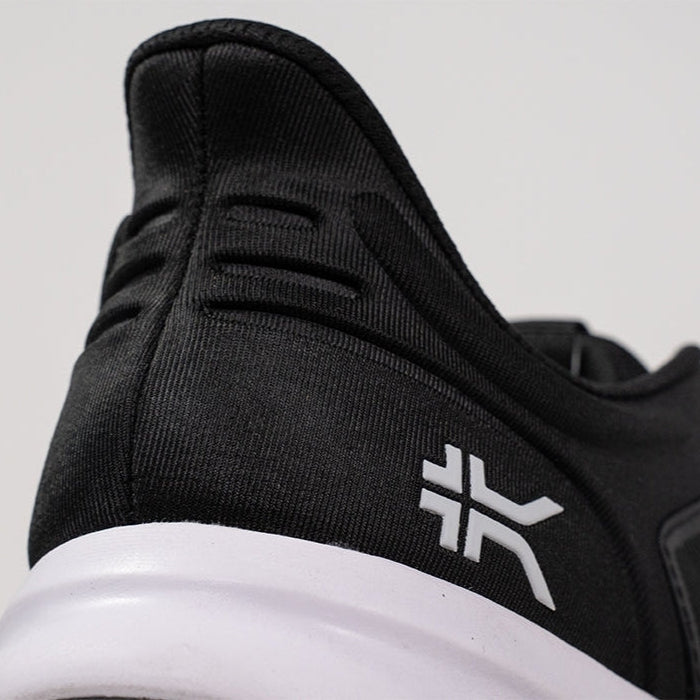 Outsole view of the KURU ATOM Fusion Women's Sneaker in Jet Black-Bright White, showing the KURUSOLE tread.