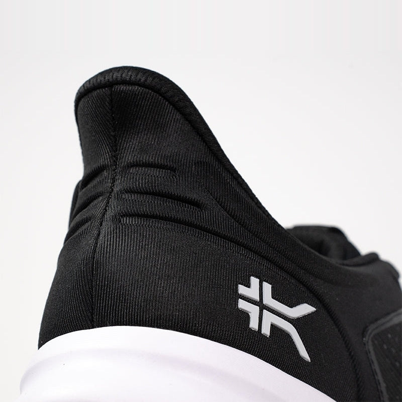 Outsole view of the KURU ATOM Fusion Men's Sneaker in Jet Black-Bright White, showing the KURUSOLE tread.