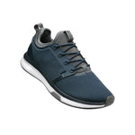 Angled profile view of the KURU ATOM Men's Sneaker in Indigo-White-Basalt.