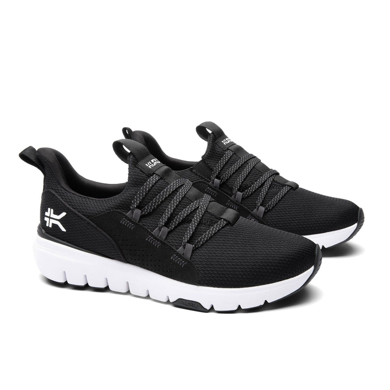 Angled profile view of the KURU FLEX Slip-On Men's Sneaker in Jet Black-Bright White.