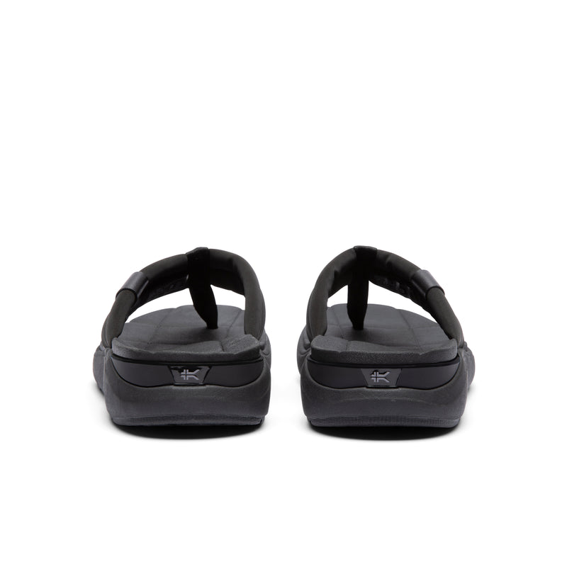 Back heel view of the KURU MOMENT Flip Men's Flip-Flop in Jet Black.