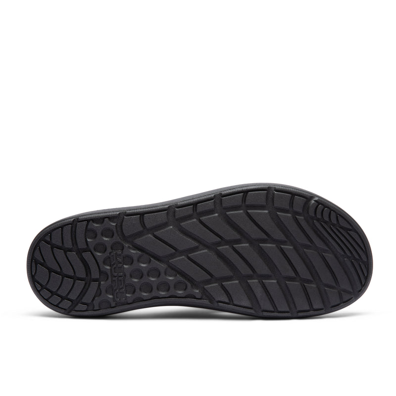 Outsole view of the KURU MOMENT Flip Men's Flip-Flop in Jet Black, showing the KURUSOLE tread.