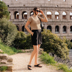 Angled profile view of the KURU MOMENT Flip Women's Flip-Flop in Jet Black.