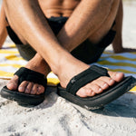 Pair of KURU MOMENT Flip Men's Flip-Flop in Jet Black, angled view.