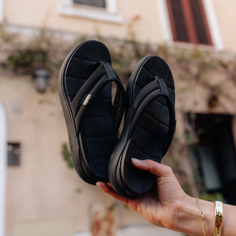 Pair of KURU MOMENT Flip Women's Flip-Flop in Jet Black, angled view.