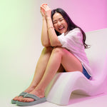 Pair of KURU MOMENT Flip Women's Flip-Flop in Safari Green, angled view.