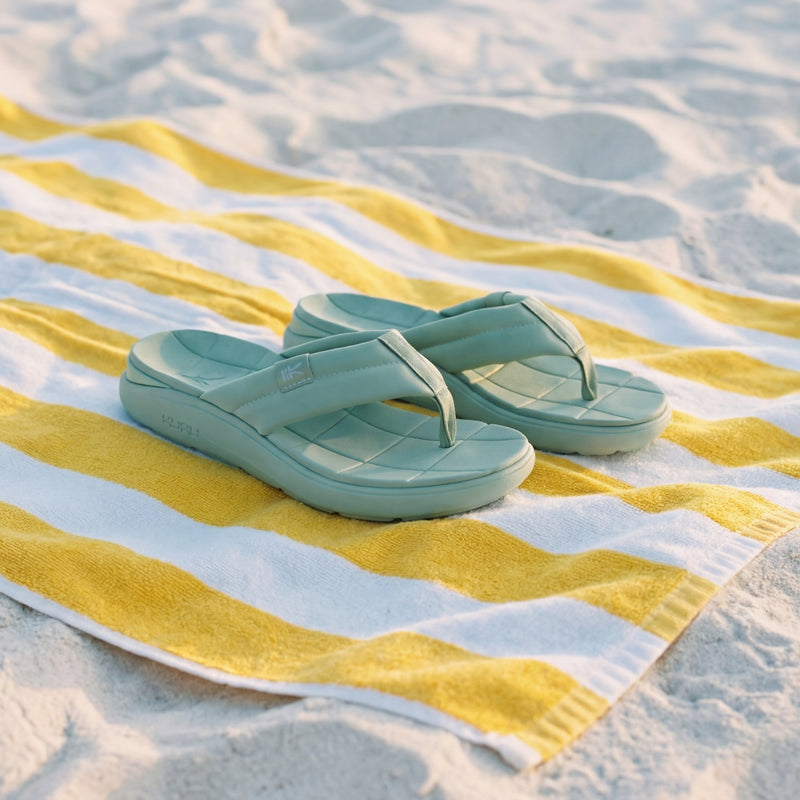 Angled profile view of the KURU MOMENT Flip Women's Flip-Flop in Safari Green.