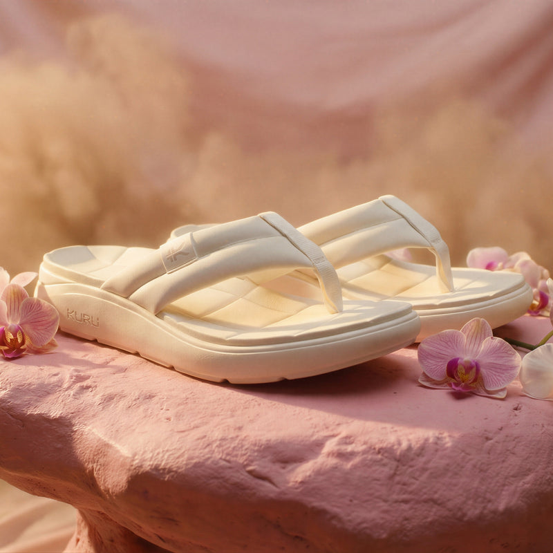 Angled profile view of the KURU MOMENT Flip Women's Flip-Flop in Ecru.