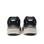 Back heel view of the KURU SURGE Unisex Sneaker in Jet Black-Bone Gray.