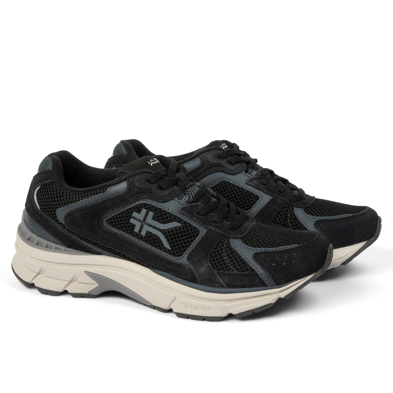 Pair of KURU SURGE Unisex Sneaker in Jet Black-Bone Gray, angled view.