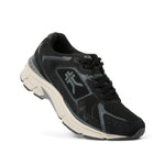 Angled profile view of the KURU SURGE Unisex Sneaker in Jet Black-Bone Gray.