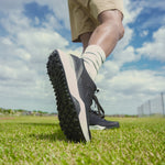 Angled profile view of the KURU DRIVE Golf Unisex Golf Shoe in Jet Black-Bright White.