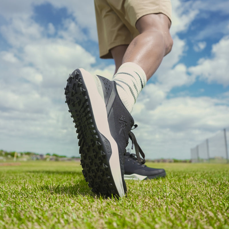 Angled profile view of the KURU DRIVE Golf Unisex Golf Shoe in Jet Black-Bright White.