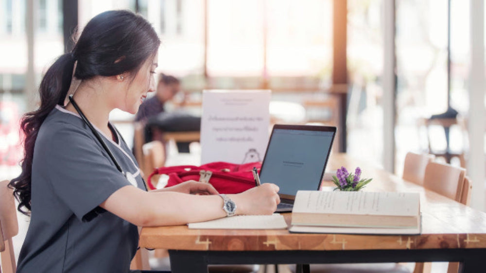Student studying at a desk, representing KURU Footwear's scholarship program.