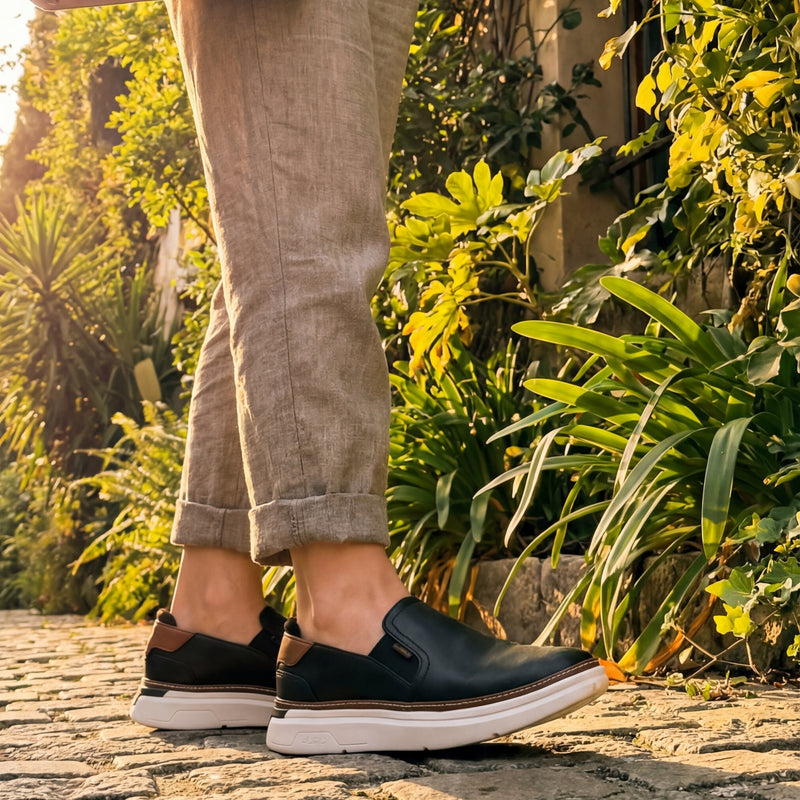 Angled profile view of the KURU ROAM 2 Atla Women's Sneaker in Jet Black-Cognac Brown.